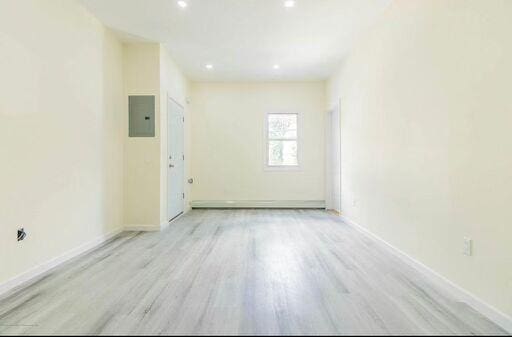 88 Taft Ave, Staten Island, NY 10301 - unfurnished room with electric panel, wood finished floors, and recessed lighting