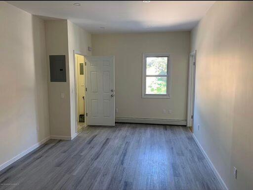88 Taft Ave, Staten Island, NY 10301 - unfurnished room with electric panel and wood finished floors