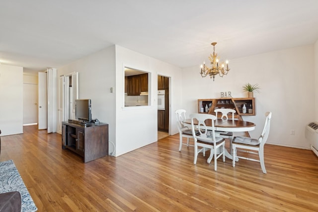 dining area with a notable chandelier and light wood-type flooring