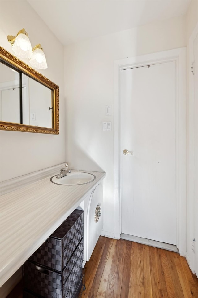 bathroom with hardwood / wood-style floors and sink