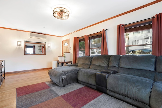 living room with a wall mounted air conditioner, light hardwood / wood-style flooring, and crown molding