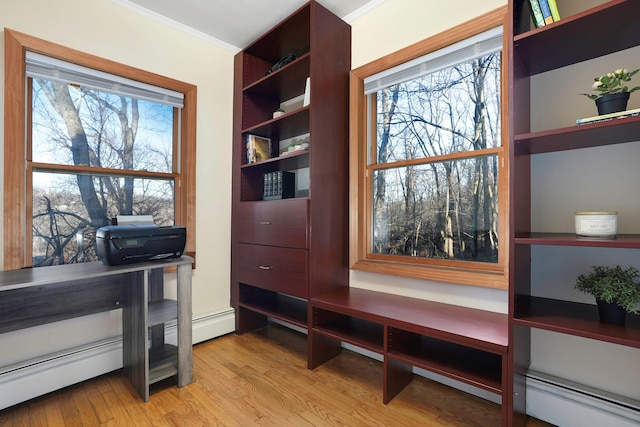 home office with a healthy amount of sunlight, ornamental molding, and baseboard heating