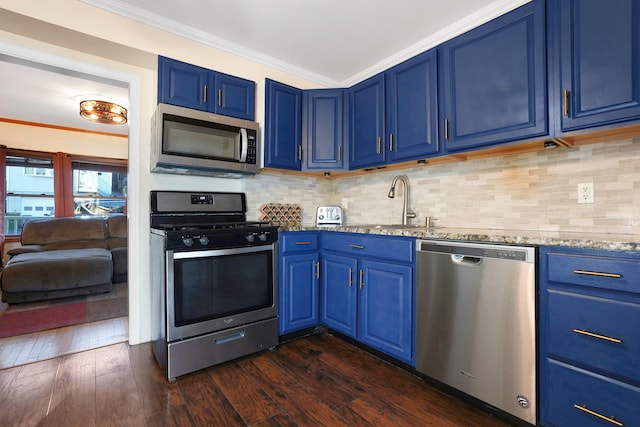 kitchen with blue cabinetry, dark wood-type flooring, and stainless steel appliances