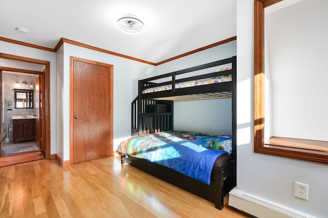 bedroom featuring connected bathroom, ornamental molding, a baseboard radiator, and light wood-type flooring