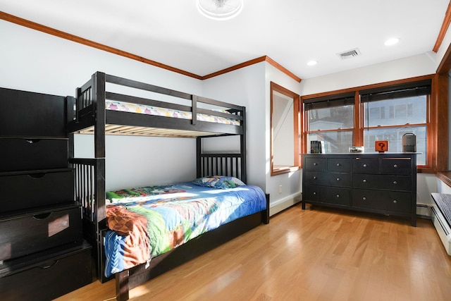 bedroom featuring light wood-type flooring and ornamental molding