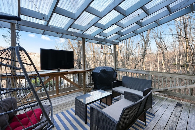 wooden terrace featuring a pergola, a grill, and an outdoor living space