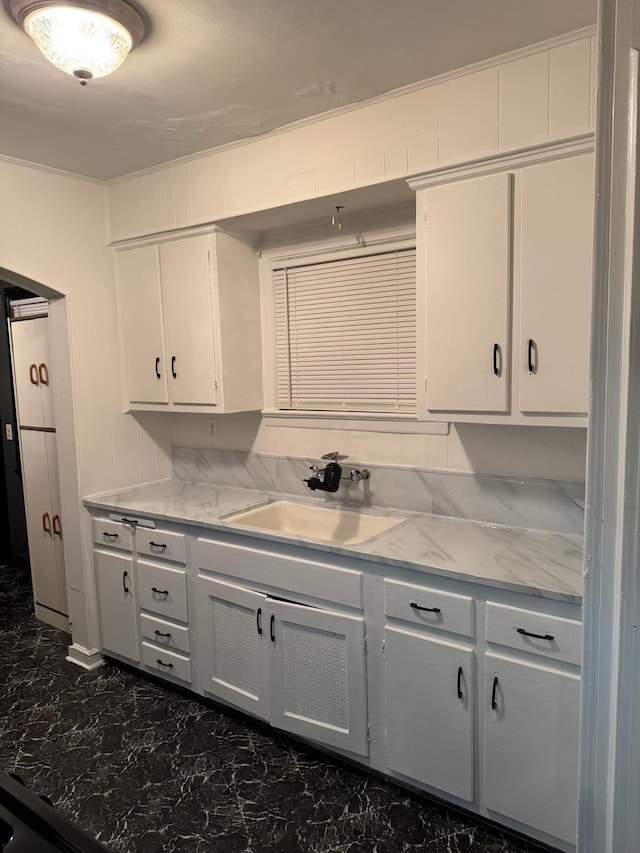 kitchen with light stone counters and sink