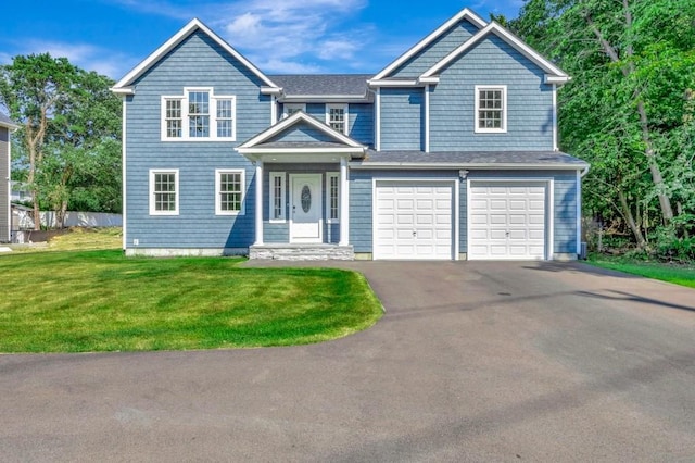 view of front of home featuring a front lawn and a garage