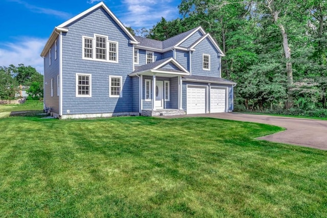 view of front of property featuring a garage and a front lawn