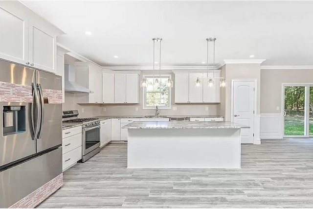 kitchen featuring pendant lighting, a center island, white cabinetry, and stainless steel appliances