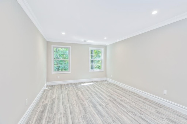 empty room with light hardwood / wood-style flooring and crown molding