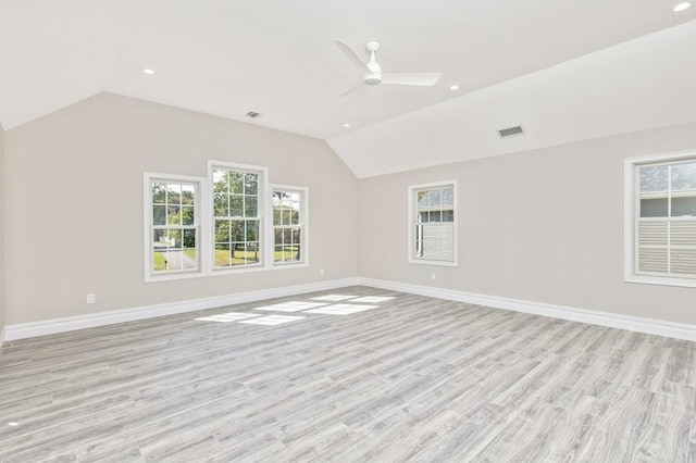 empty room with ceiling fan, light hardwood / wood-style floors, and lofted ceiling