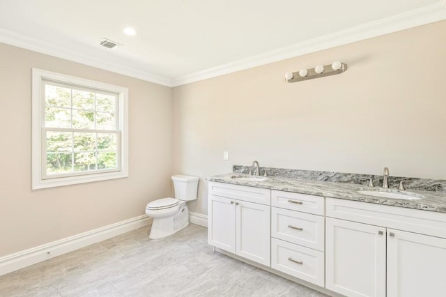 bathroom with vanity, toilet, and crown molding