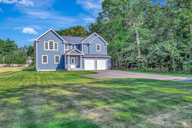 view of front of home with a garage and a front lawn