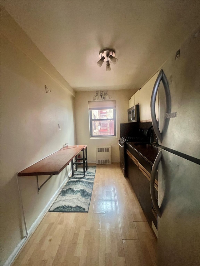 misc room with radiator and light hardwood / wood-style flooring