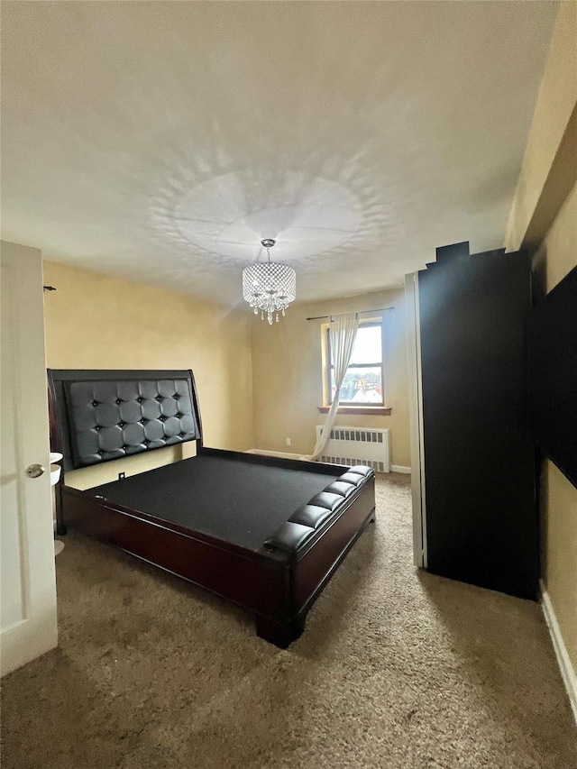 playroom featuring a notable chandelier, radiator heating unit, and carpet floors