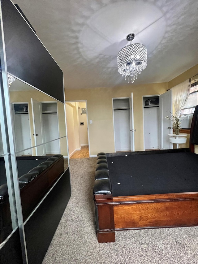 rec room with carpet floors, billiards, and an inviting chandelier