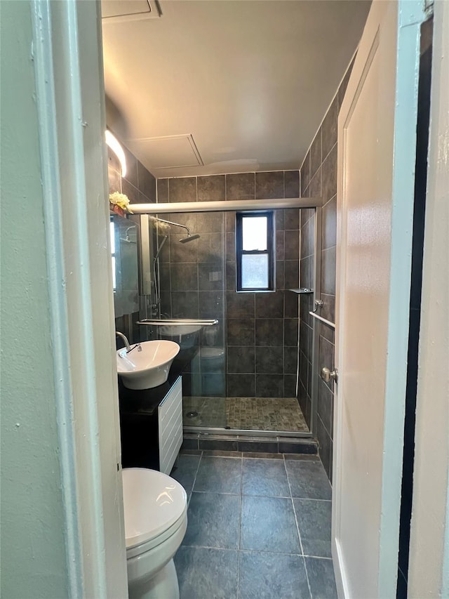 bathroom featuring tile patterned flooring, vanity, toilet, and an enclosed shower