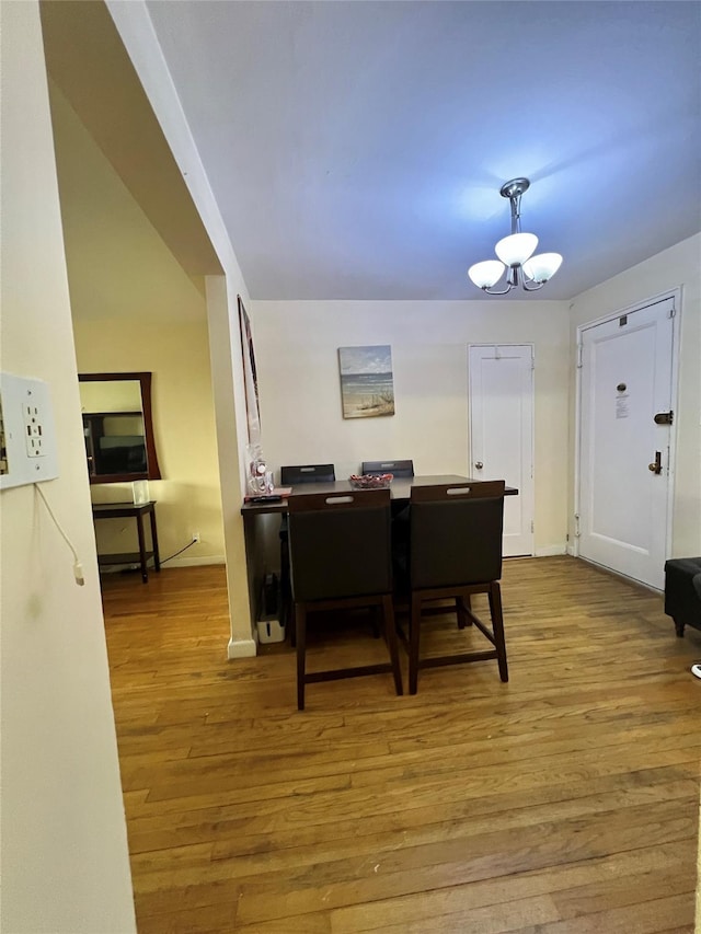 dining room with a notable chandelier and light hardwood / wood-style flooring