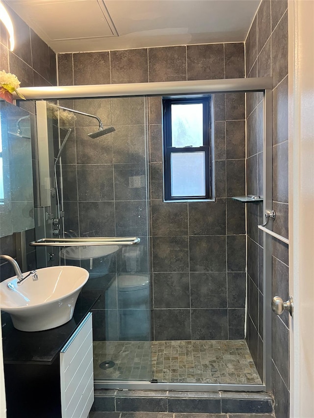 bathroom with vanity and a shower with shower door