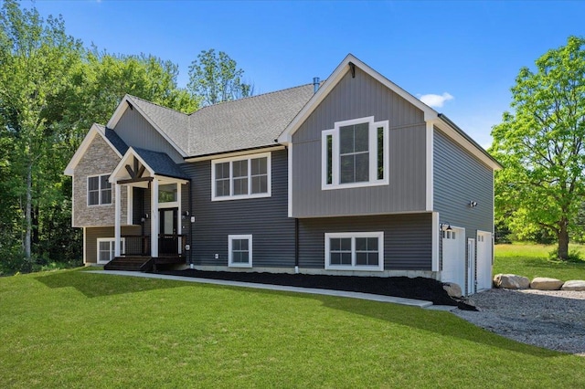 raised ranch with a garage and a front lawn