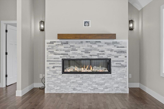 interior details featuring a fireplace and wood-type flooring