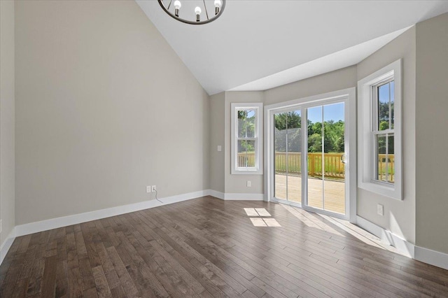 unfurnished room with dark hardwood / wood-style flooring, high vaulted ceiling, and a notable chandelier