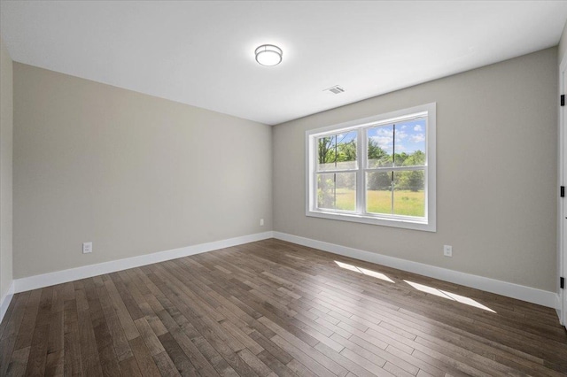 spare room featuring dark hardwood / wood-style flooring