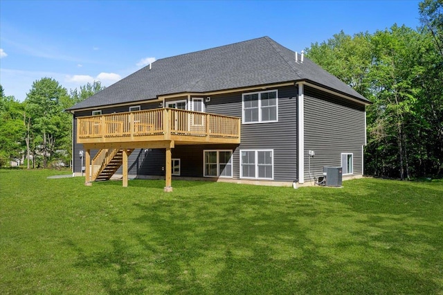 back of property featuring central AC unit, a deck, and a lawn