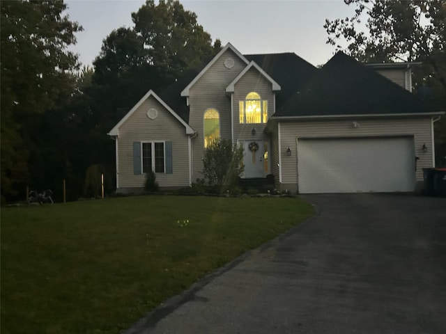 front of property with a front yard and a garage