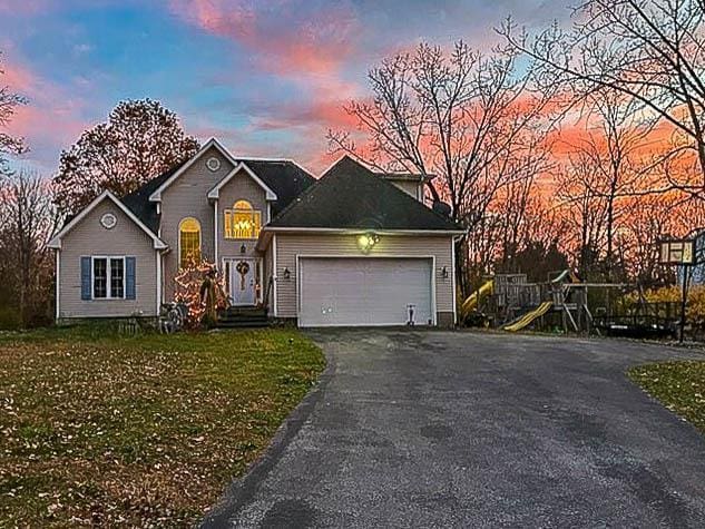 view of front of property featuring a yard and a garage