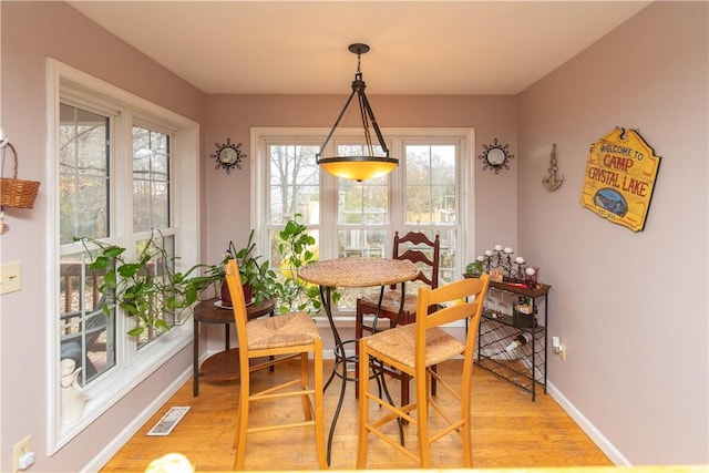 dining space with light wood-type flooring