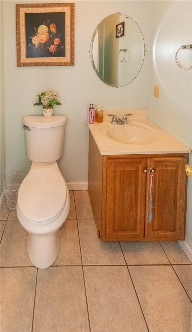 bathroom with tile patterned flooring, vanity, and toilet