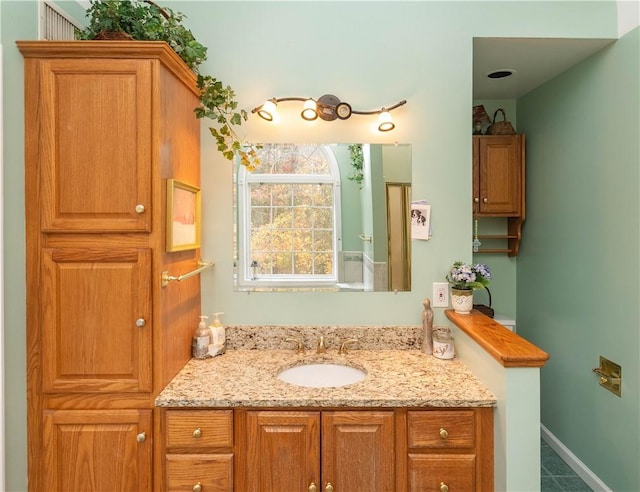 bathroom featuring tile patterned flooring and vanity