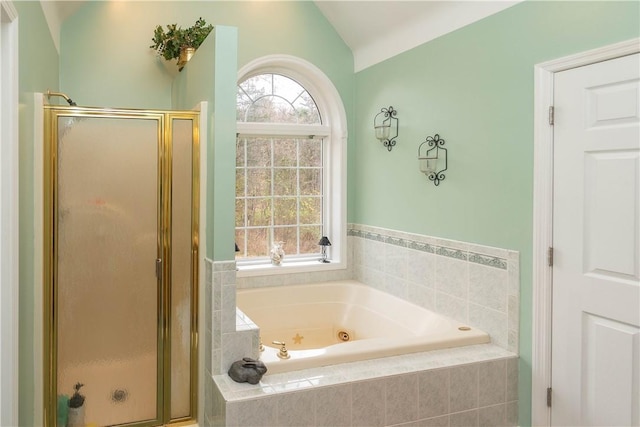 bathroom featuring shower with separate bathtub and vaulted ceiling