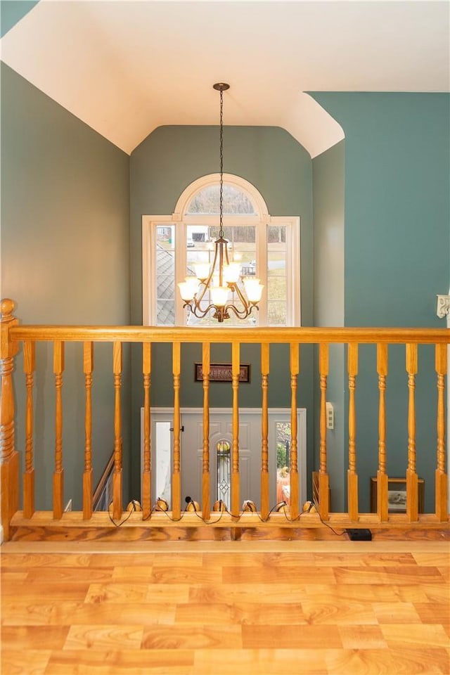 interior space with hardwood / wood-style floors, lofted ceiling, and a chandelier