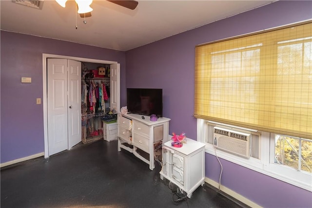 interior space with ceiling fan and cooling unit