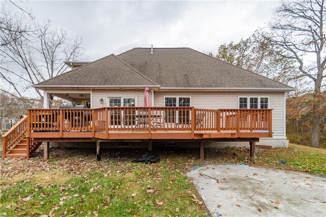 rear view of house featuring a wooden deck