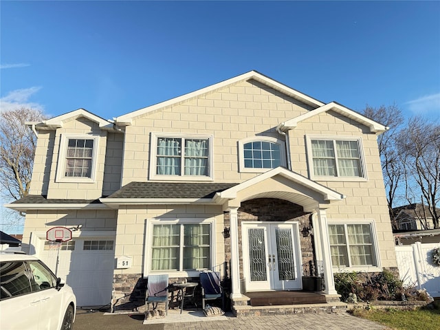 view of front of property featuring french doors and a garage