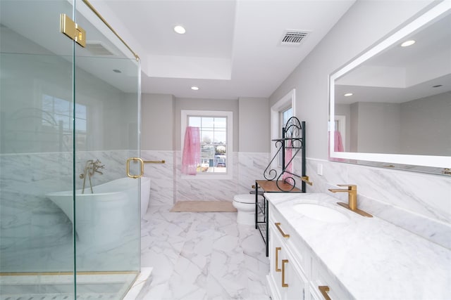 full bathroom featuring separate shower and tub, vanity, tile walls, and toilet