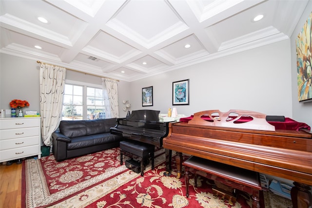 living area featuring coffered ceiling, beam ceiling, crown molding, and light hardwood / wood-style flooring