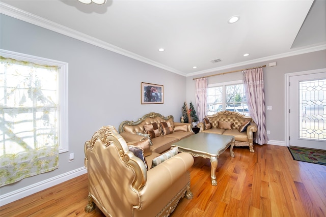 living room featuring crown molding and light hardwood / wood-style flooring