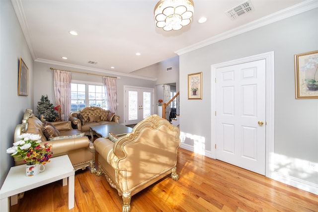 living room featuring ornamental molding, french doors, and light hardwood / wood-style flooring