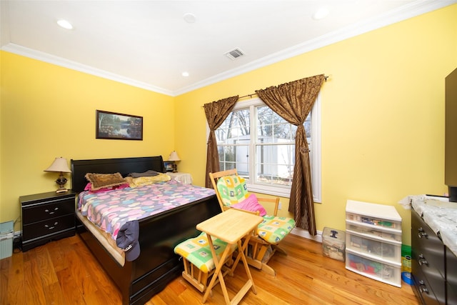 bedroom featuring hardwood / wood-style flooring and crown molding