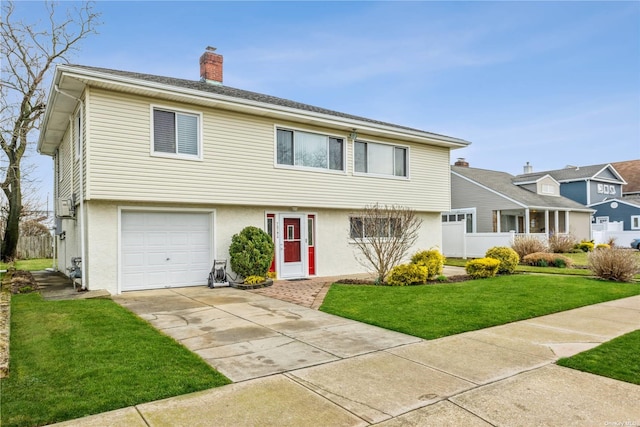 view of front of house with a garage and a front lawn