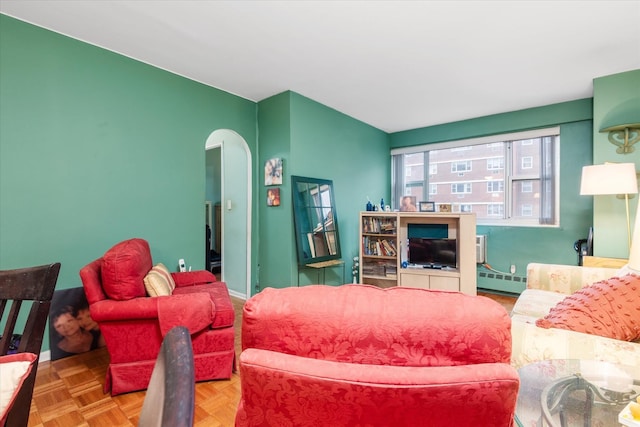 living room with parquet floors and a baseboard heating unit