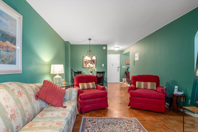 living room featuring parquet floors and a chandelier