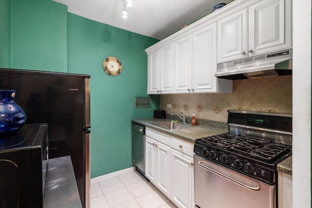 kitchen with white cabinets, sink, decorative backsplash, appliances with stainless steel finishes, and light tile patterned flooring