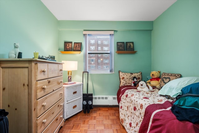 bedroom with light parquet flooring and baseboard heating