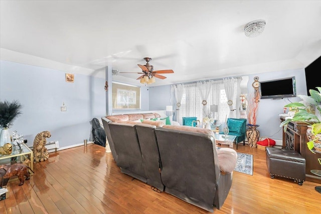 living room featuring ceiling fan, light hardwood / wood-style flooring, and a healthy amount of sunlight